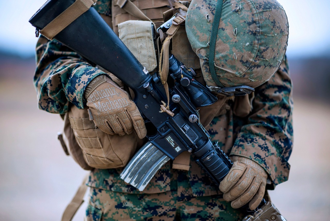 Marine holding gun while wearing cammies.