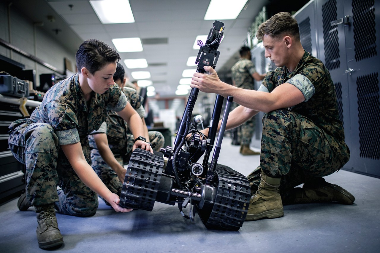 Marine moving boxes of coffee during the Chaplain’s coffee giveaway at the Distribution Management Office.