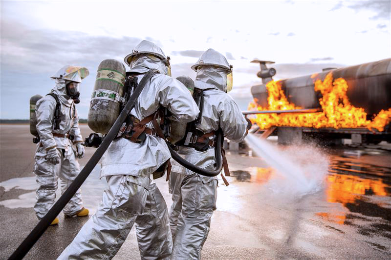 Firefighting specialists in the airfield services MOS field putting out flames.