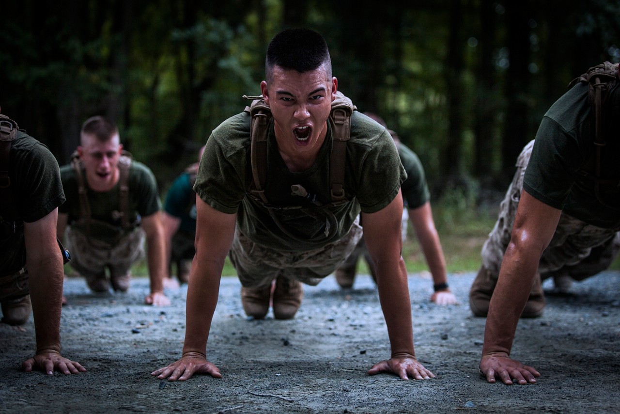 Officer candidates perform push-ups during the Medal of Honor run at Officer Candidates School aboard Marine Corps Base Quantico, Virginia, August 15, 2019. The mission of Officer Candidates School is to educate and train officer candidates in Marine Corps knowledge and skills within a controlled and challenging environment in order to evaluate and screen individuals for the leadership, moral and physical qualities required for commissioning as a Marine Officer. (U.S. Marine Corps photo by Lance Cpl. Phuchung Nguyen)