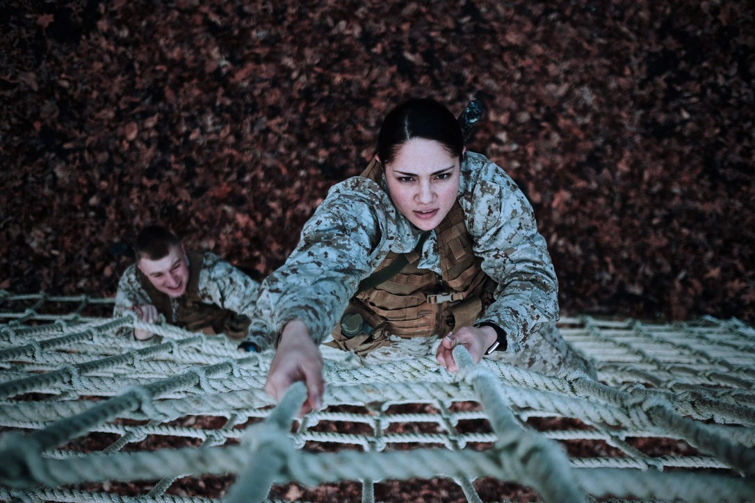 Two Marines on the ropes course during training