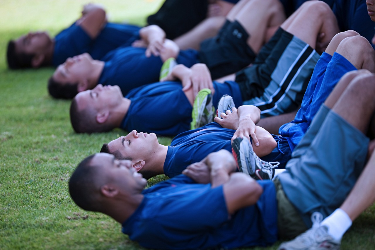 Marine recruits doing crunches during training.