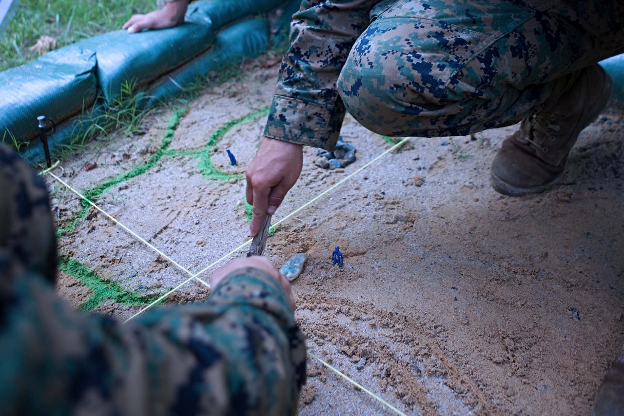 Marines consulting with their peers during battle strategy 