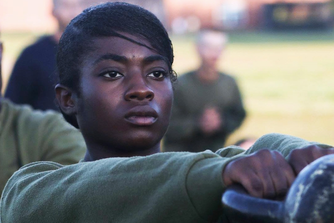 Aspiring Marine using kettlebell to show physical strength.