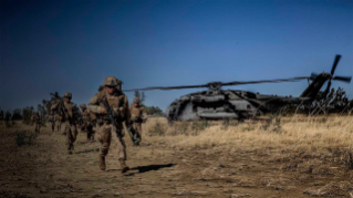 Marines exit a CH-53E Super Stallion.