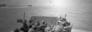 Marines approach Iwo Jima from the sea in this black and white photo.