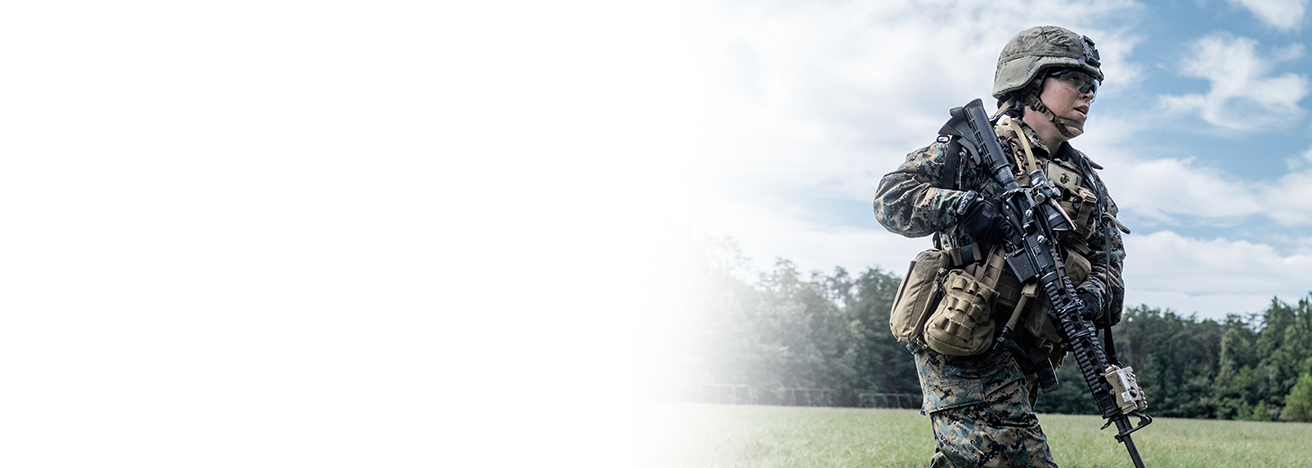 Marine in woodland camouflage uniform with rifle advancing during Rifle Platoon Preparation training exercise.