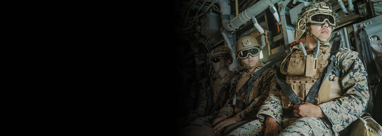 Marines in combat gear aboard amphibious assault craft during coordinated sea-based operations training.