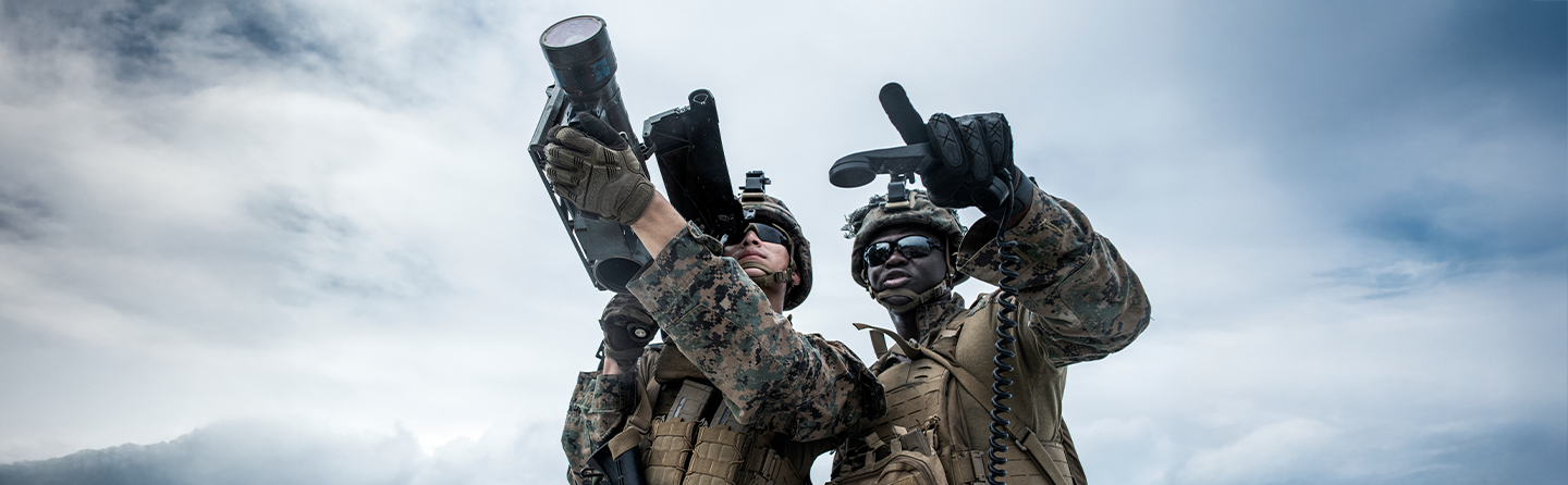 Marines operating advanced tactical equipment and communication systems during modern warfare training exercise.