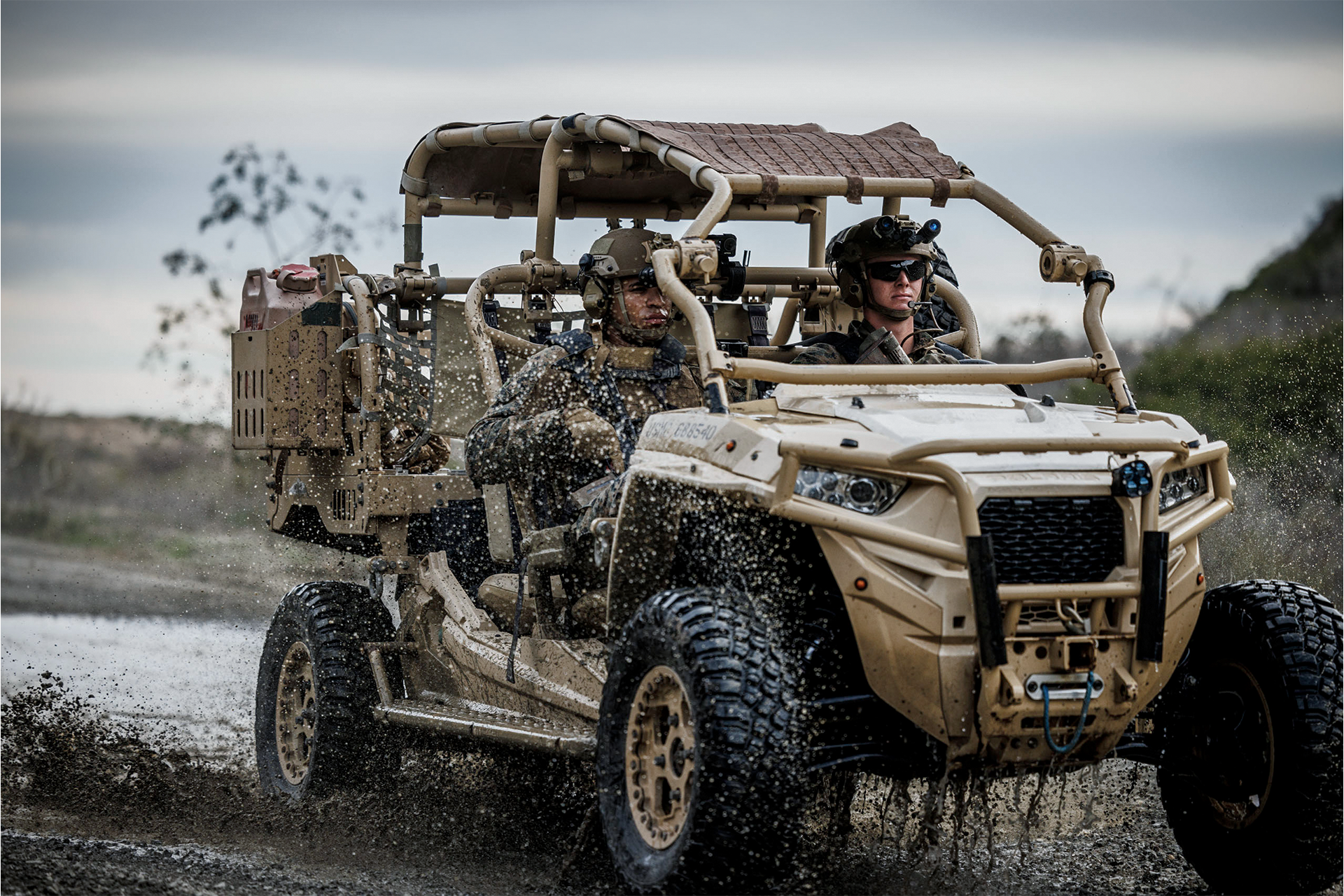 Marines drive MRZR light tactical vehicle through muddy water during off-road training at Camp Pendleton.