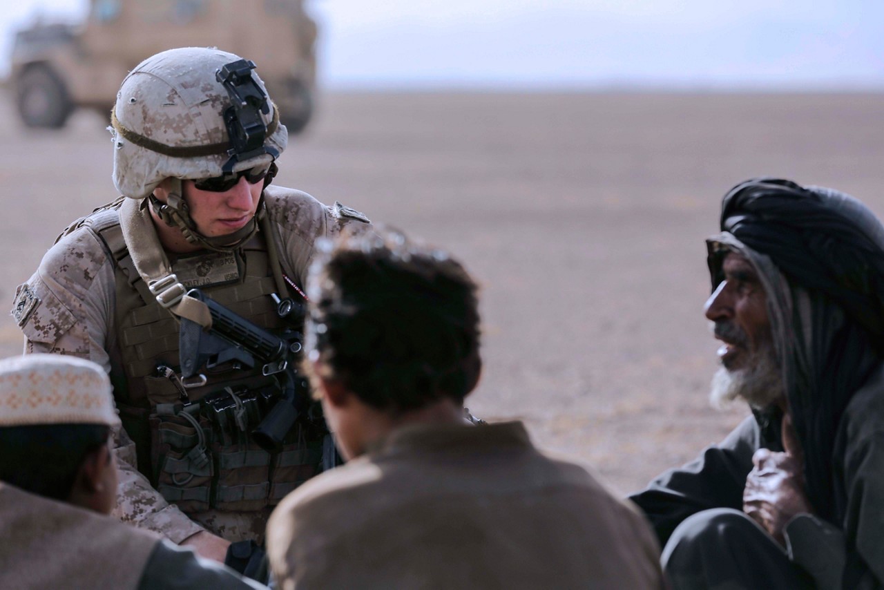 U.S. Marine Cpl. Justin Hinckley, a team leader with Weapons Company, 1st Battalion, 2d Marine Regiment, talks to a local family of the Washer district during a security patrol in Helmand province, Afghanistan on July 16, 2014. Patrols are conducted to disrupt enemy operations against Bastion- Leatherneck Complex. (U.S. Marine Corps photo by Cpl. John A. Martinez Jr./Released)