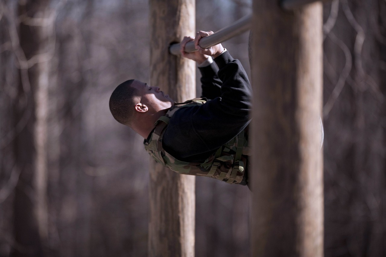 Aspiring Marine midway through doing a pull up.