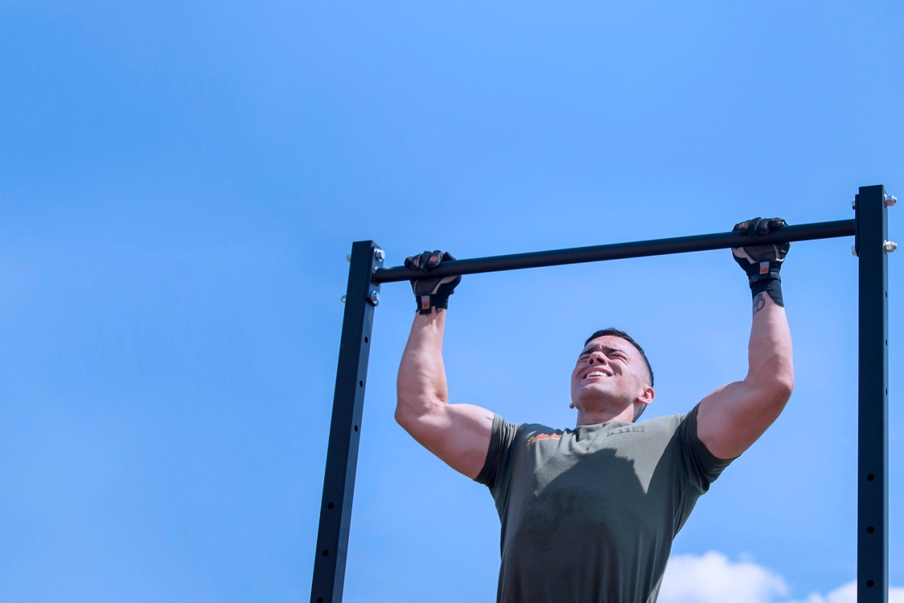 Aspiring Marine recruits doing pull ups as a group.