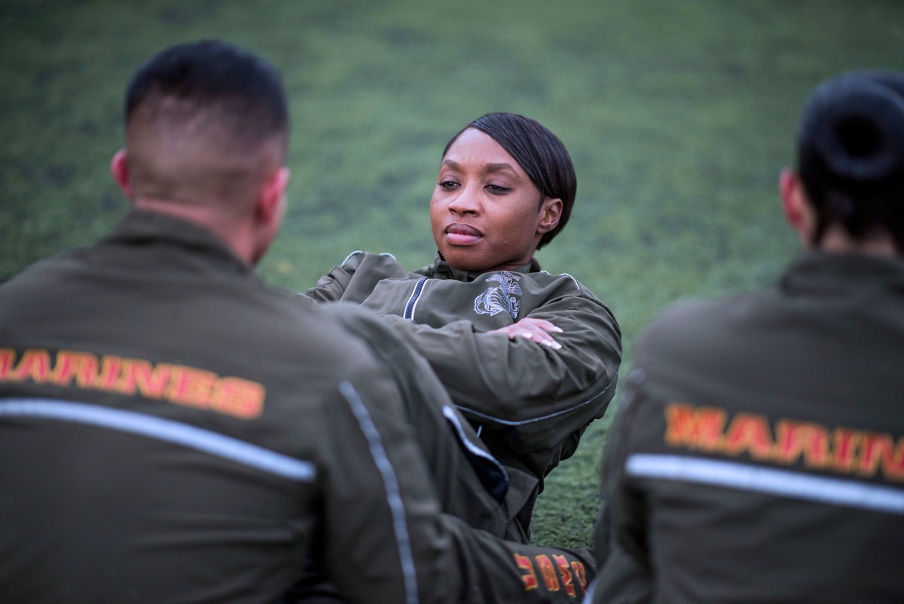 Aspiring Marine doing pull ups to showcase physical fitness.