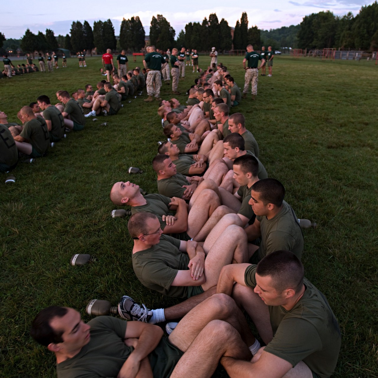 Aspiring Marine recruits doing pull ups as a group.